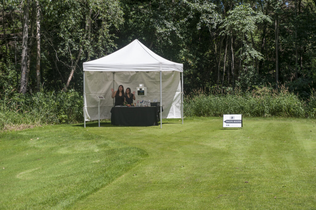 Photobooth set up in a field of grass.
